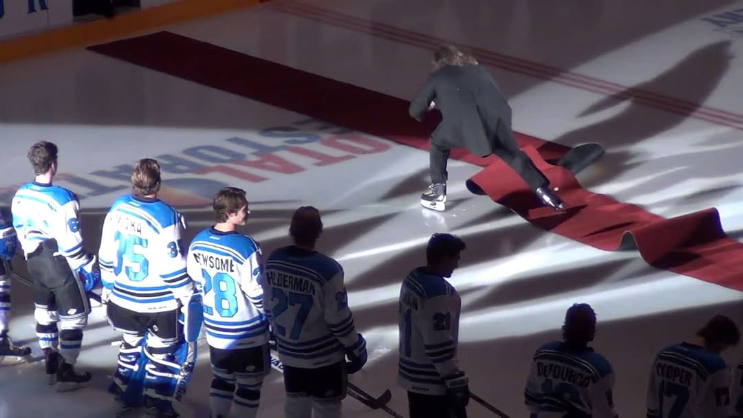 Guy falls during national anthem but keeps on singing